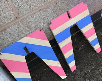 The finished CNC stools with painted stripes in pink and blue to be donated to Toxteth Town Hall community centre